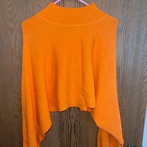 Cropped orange turtle neck with cute sleeves. Barely worn